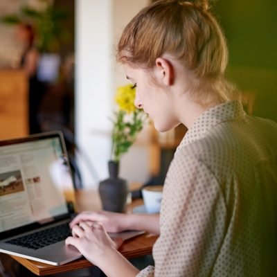 Laptop,,Typing,And,Woman,In,Cafe,With,Content,Writing,,Travel